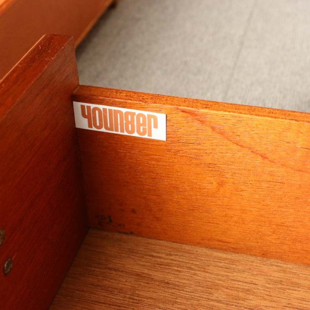 Close-up of vintage teak sideboard drawer interior showing clear wood grain and Younger brand label, British mid-century.