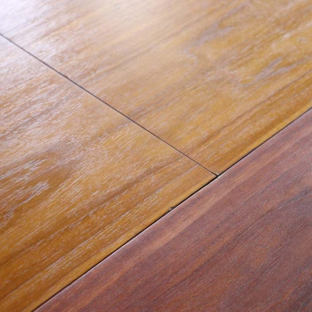 Close-up of vintage teak dining table surface showing mid-century British design wood grain and smooth finish.