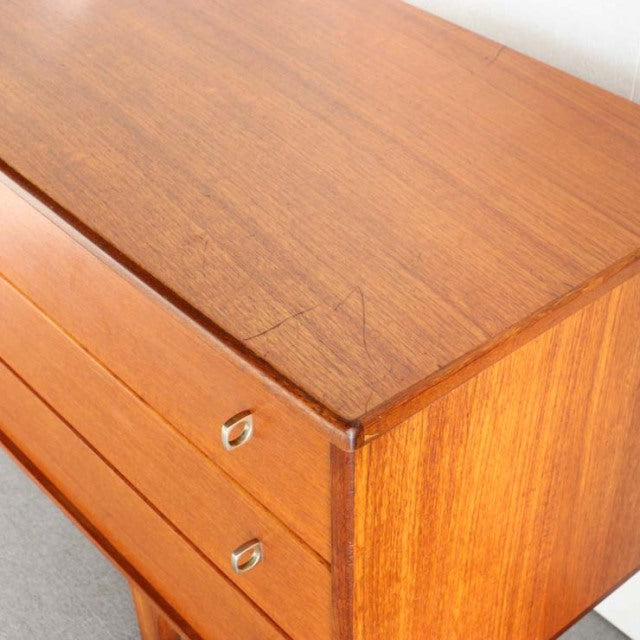 Vintage mid-century teak sideboard by Younger, British-Denmark design, sleek wood grain, metal handles, clean rectangular.