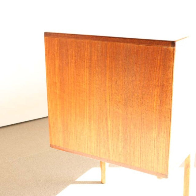 Vintage teak sideboard by Younger with sleek mid-century British design, smooth wood grain, and slender tapered legs.