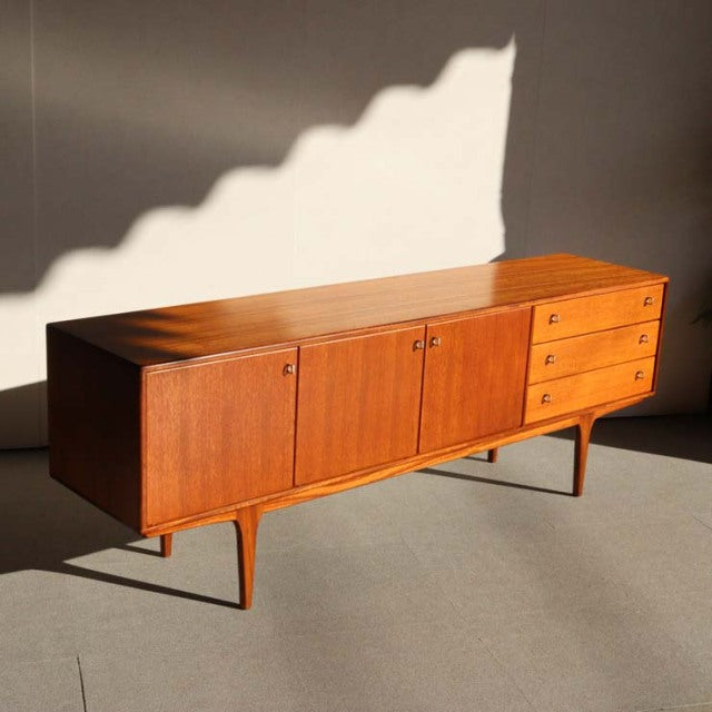 Mid-century vintage teak sideboard by Younger, British-Danish style, clean wood grain, tapered legs, three doors, three.