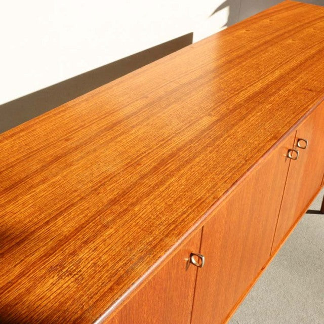 Vintage teak sideboard by Younger, British mid-century design with rich wood grain and polished finish, sleek slender legs.