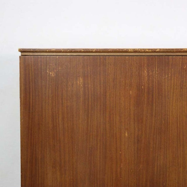 Mid-century British vintage teak sideboard with rich wood grain and sleek edges against white background.