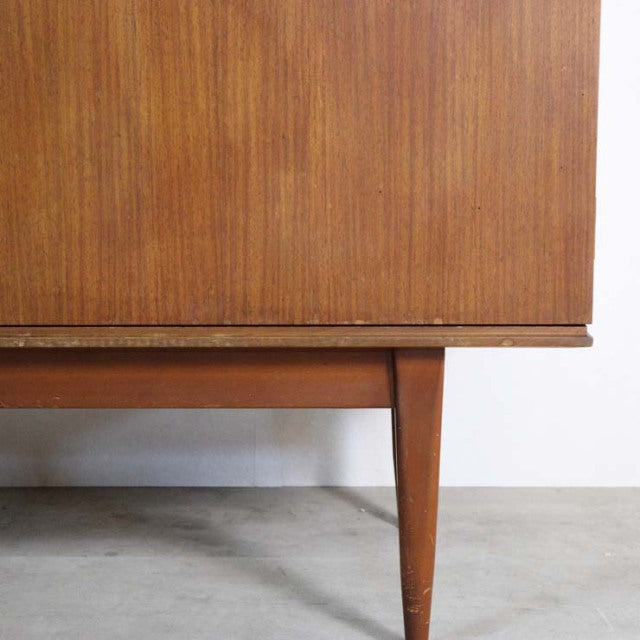 Mid-century British vintage teak sideboard leg and lower panel with fine wood grain and tapered square leg design.