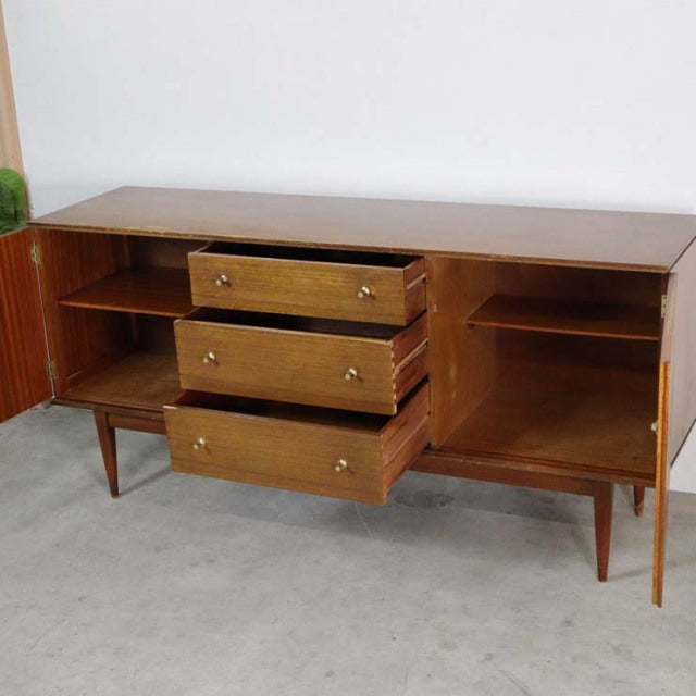 Mid-century British vintage teak sideboard with three central drawers, wooden grain finish, and tapered legs from Denmark.