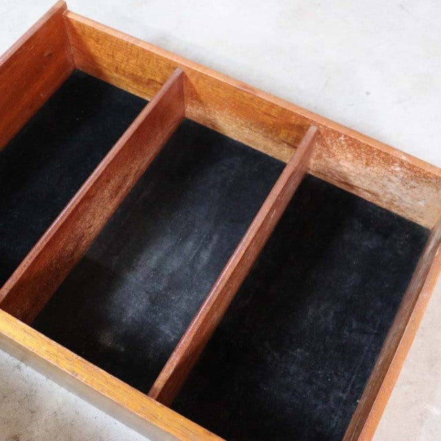 Mid-century British vintage teak sideboard drawer with black felt lining and clean wood grain dividers.