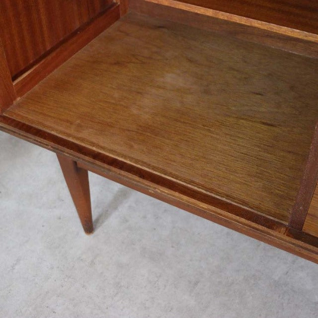 Mid-century British vintage teak sideboard top surface with rich wood grain and tapered leg detail.