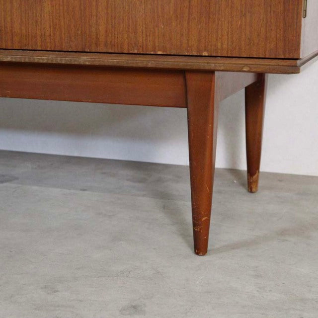 Mid-century British vintage teak sideboard leg with tapered, rounded design and warm wood grain finish.