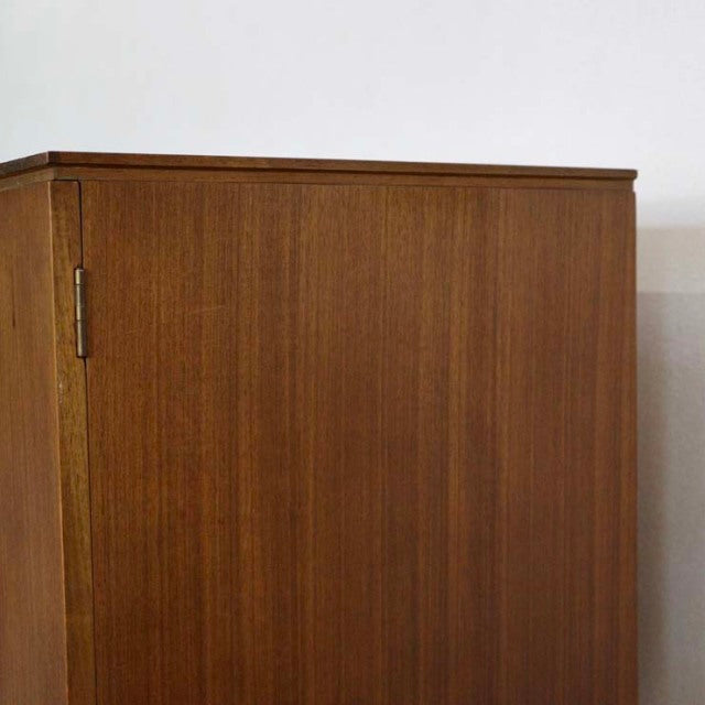 British mid-century vintage teak sideboard with smooth wood grain and minimalist rectangular form.