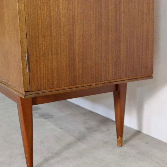 Mid-century British vintage teak sideboard with rich wood grain, tapered legs, and brass-capped feet.