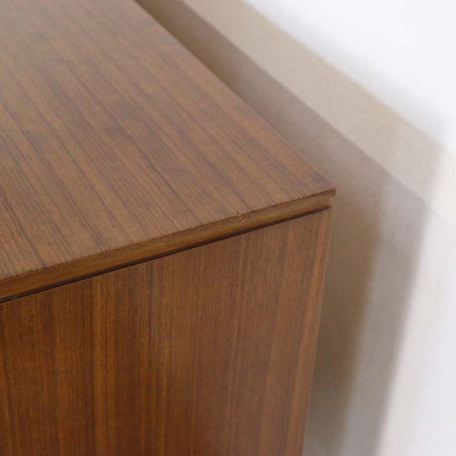 Mid-century British vintage teak sideboard corner showcasing rich wood grain and smooth, polished surface.