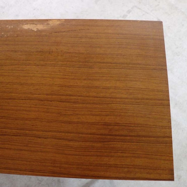 Close-up of vintage British mid-century teak sideboard top showing rich wood grain and smooth finish.