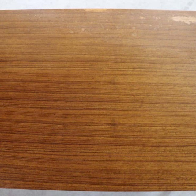 Close-up of mid-century teak wood grain showcasing warm brown tones and fine texture on vintage British sideboard surface.