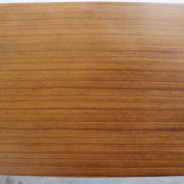 Smooth vintage teak wood surface with fine horizontal grain lines, mid-century British craftsmanship.