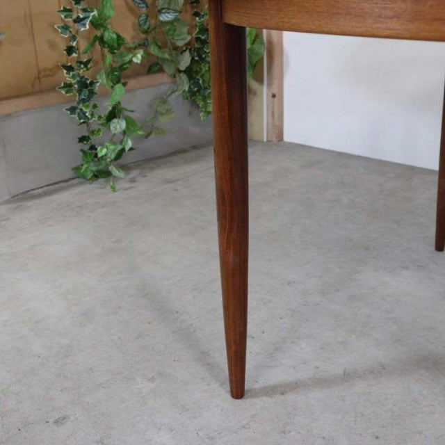 Mid-century British G-Plan teak dining table leg with smooth grain and tapered design.
