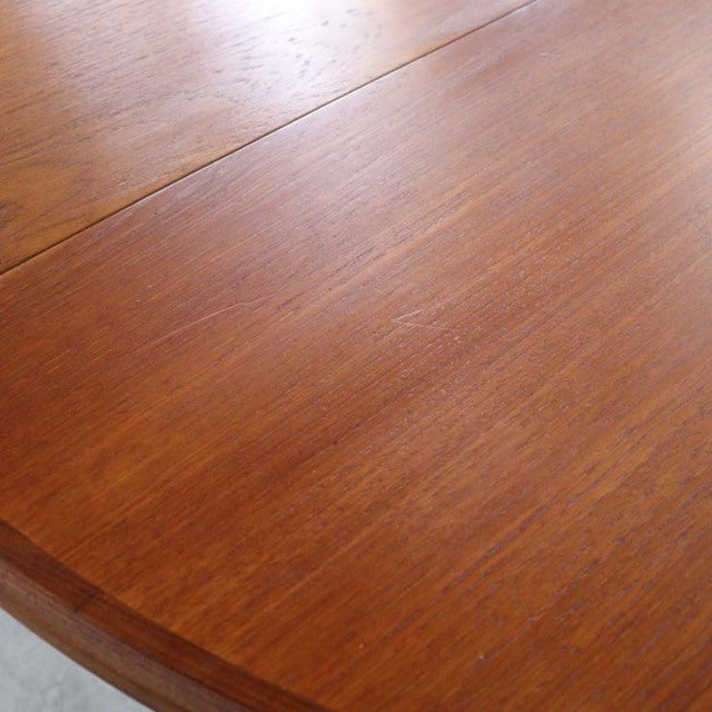 Vintage teak G-Plan mid-century dining table with smooth wood grain and rounded edges.
