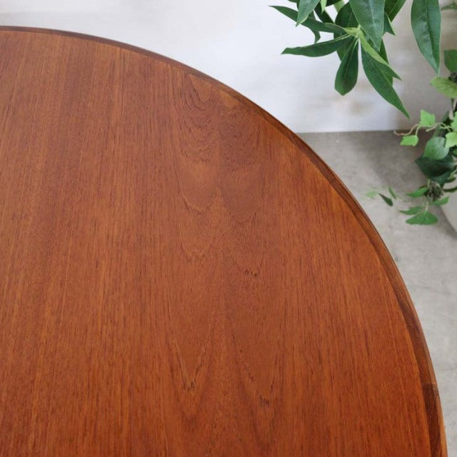 Vintage teak G-Plan British mid-century dining table with smooth oval top and warm wood grain.