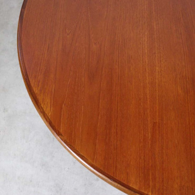 Vintage teak G-Plan dining table with smooth oval top and warm mid-century British design.