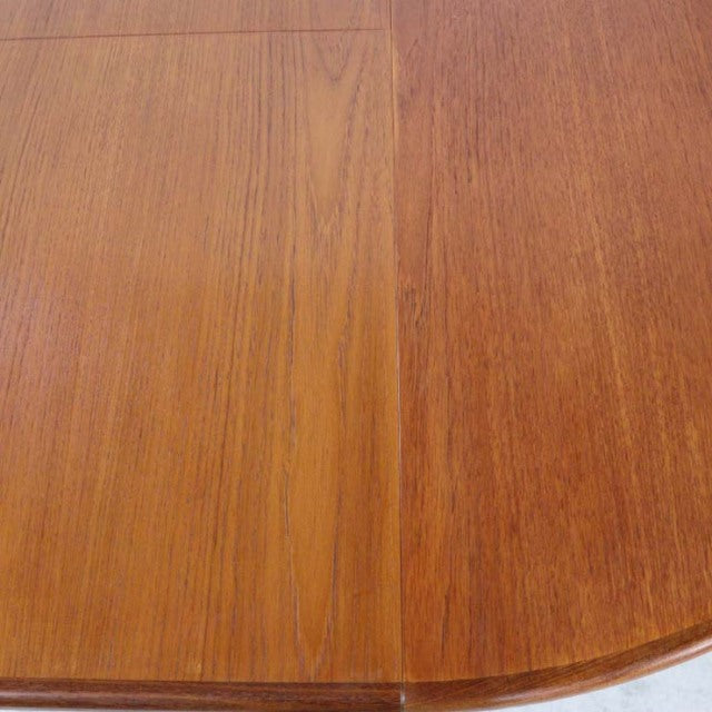 Vintage teak G-Plan mid-century dining table with oval shape and visible wood grain detailing.