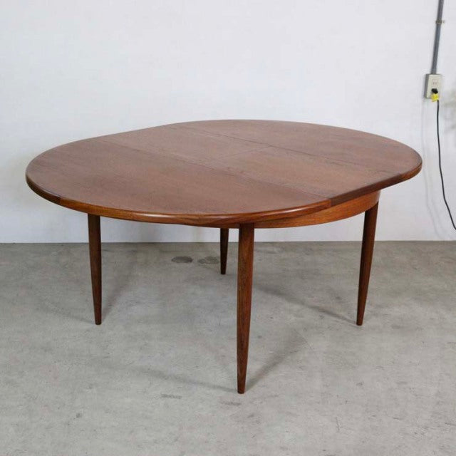 Vintage teak G-Plan mid-century British dining table with rounded edges and tapered legs.