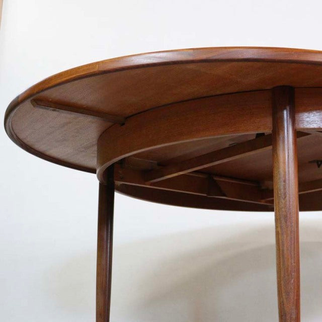 Vintage mid-century G-Plan teak dining table with round extending top and tapered wooden legs from British-Denmark design.