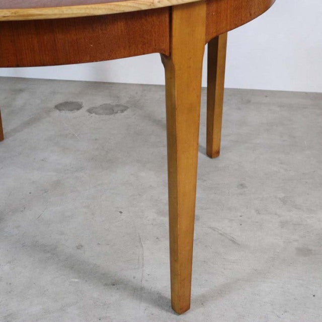 Mid-century British vintage teak dining table leg with warm wood grain and clean tapered design.