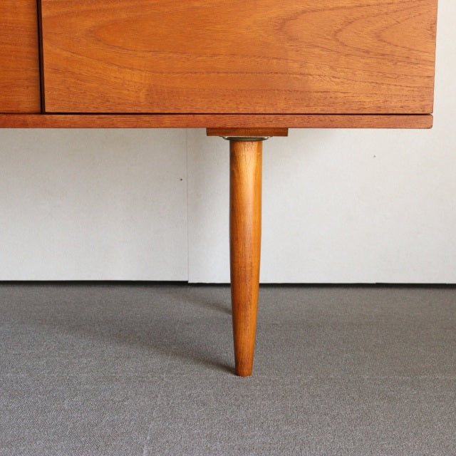 Mid-century vintage teak sideboard leg with tapered, rounded design showcasing warm wood grain and British craftsmanship by.