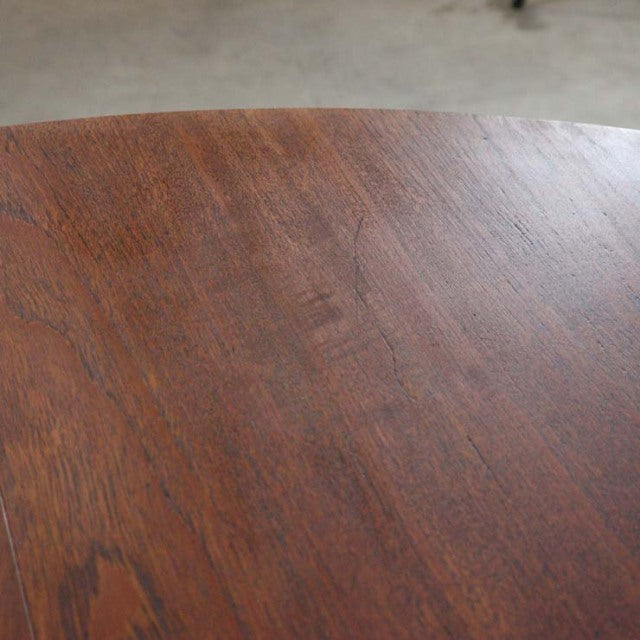 Vintage teak round dining table top showing rich wood grain with warm brown mid-century finish.