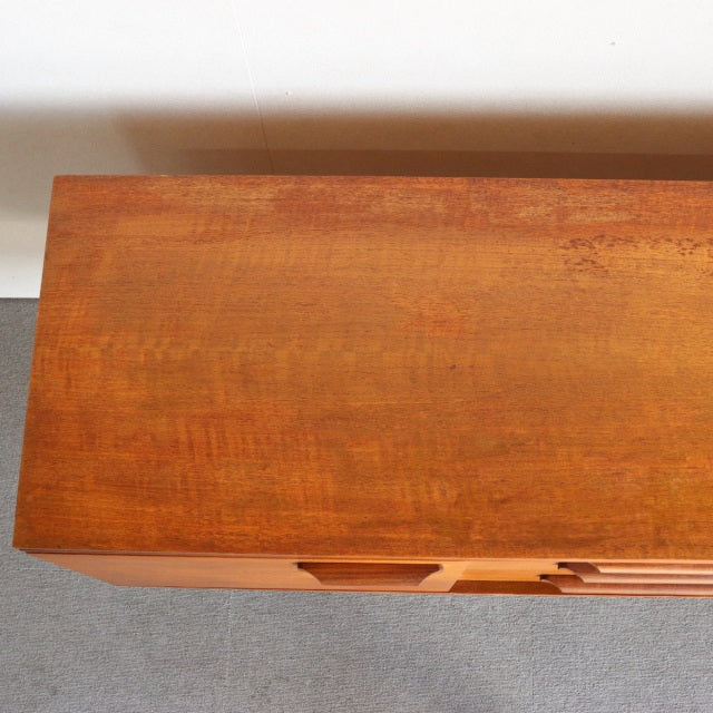 Vintage teak mid-century sideboard by William Laurence with smooth wood grain and sleek British-Denmark design.