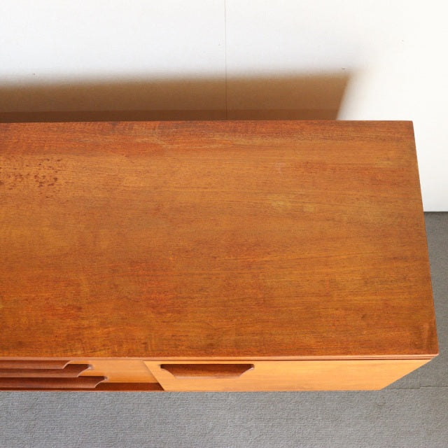 Vintage mid-century teak sideboard by William Laurence, featuring smooth wood grain and clean lines.