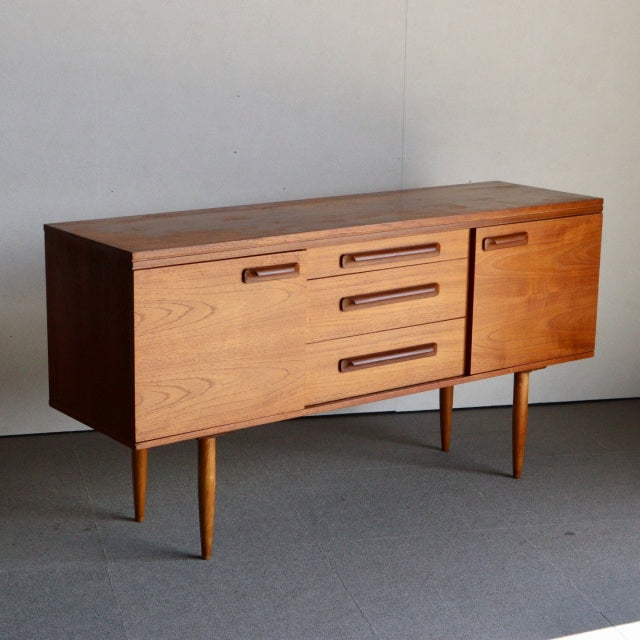 Vintage mid-century teak sideboard by William Laurence, British-Denmark design, sleek wood grain, slender tapered legs,.