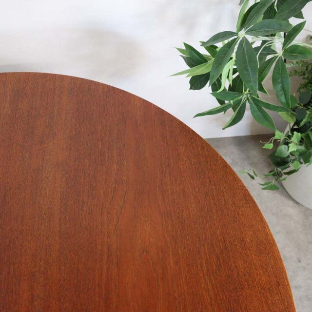 Round vintage teak dining table top with rich wood grain, showcasing mid-century British design and smooth finish.