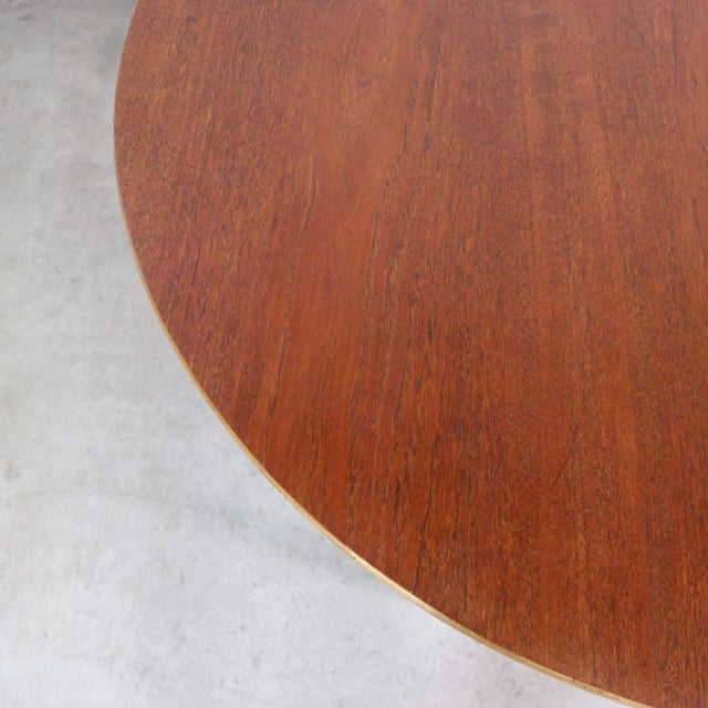 Round vintage teak dining table top showing smooth wood grain with a warm mid-century British style finish.