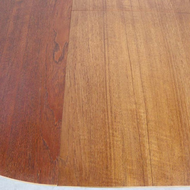 Round vintage teak dining table top with rich wood grain showcasing mid-century British and Danish design craftsmanship.