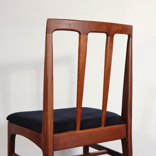 Vintage mid-century teak dining chair by YOUNGER with British-Denmark design, featuring vertical slats and black cushioned.