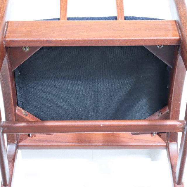 Vintage teak YOUNGER dining chair seat underside showing solid wood frame and brass corner brackets, mid-century British.