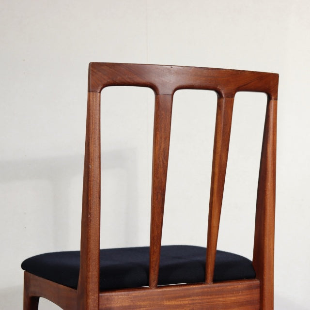 Vintage mid-century British teak dining chair with slender vertical slats and black upholstered seat.