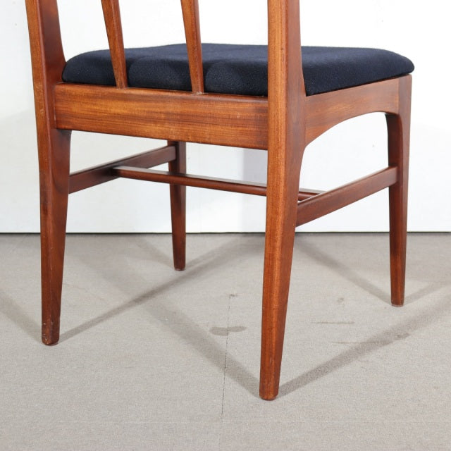 Mid-century British vintage teak dining chair with sleek tapered legs and dark upholstered seat.