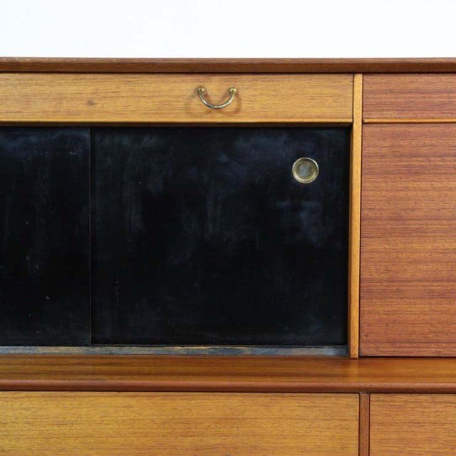 Vintage mid-century G-Plan teak highboard featuring a rich wood grain, black sliding doors, brass handles, and clean.