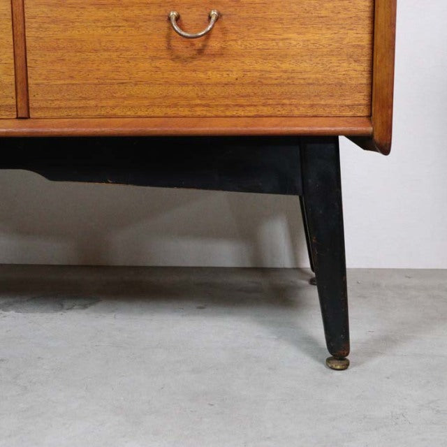 Vintage teak mid-century British G-Plan LIBRENZA highboard leg with black tapered wood and brass caster detailing.