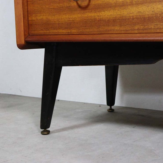 Mid-century British G-Plan LIBRENZA highboard with sleek black tapered legs and warm teak wood grain detail.