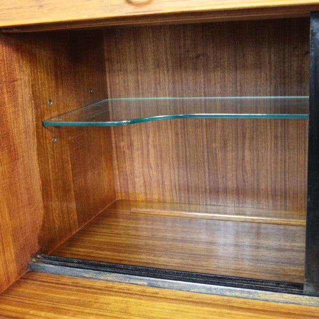 Vintage teak wood highboard interior with mid-century British design, clear glass shelf, and rich wood grain detail.