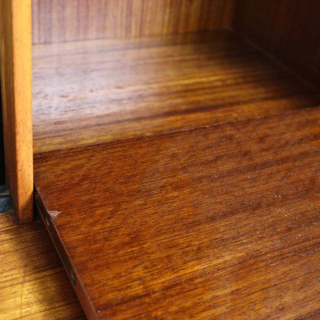 Close-up of vintage teak wood grain on mid-century British G-Plan Librenza highboard shelf panel with smooth finish and warm .