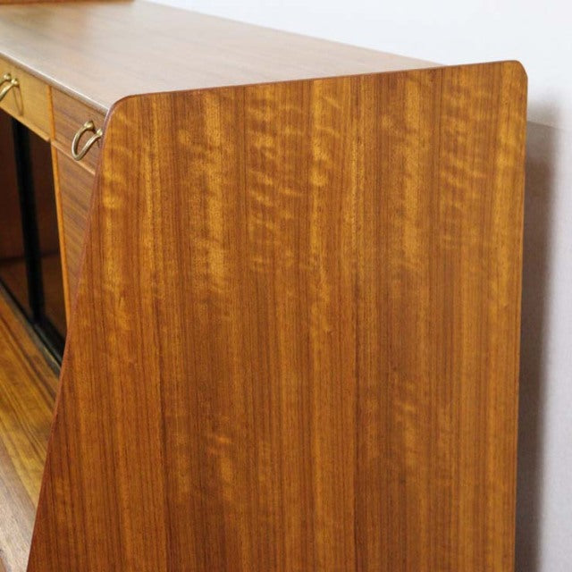 Vintage teak G-Plan mid-century sideboard with rich wood grain and sleek angled legs, British design.
