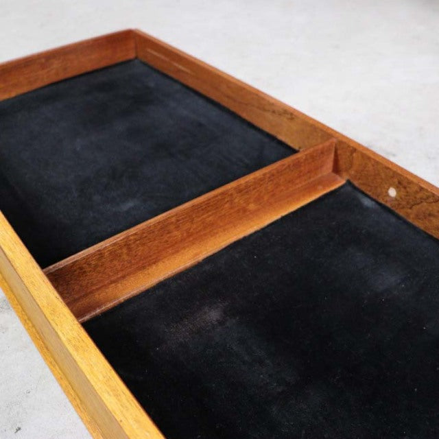 Vintage teak G-Plan mid-century highboard drawer interior with soft black felt lining and warm wood grain edges.