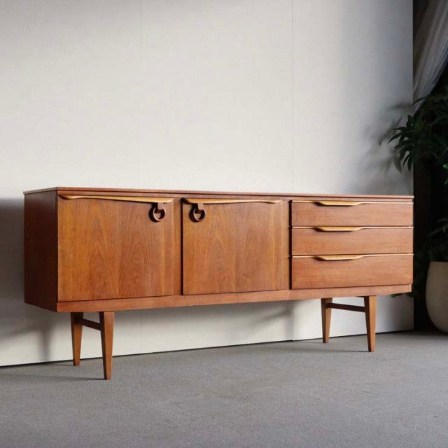 Vintage teak sideboard by Beautility featuring British mid-century design, smooth grain, tapered legs, and integrated handles.