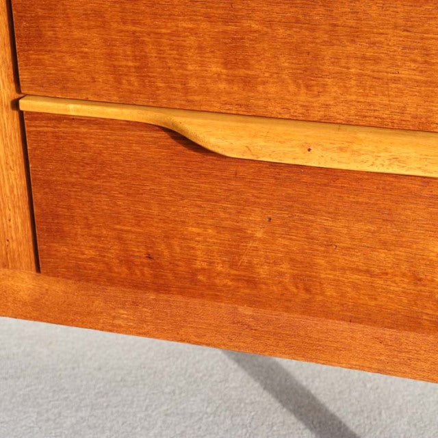 Vintage teak sideboard panel with smooth wood grain and sleek mid-century British design details.