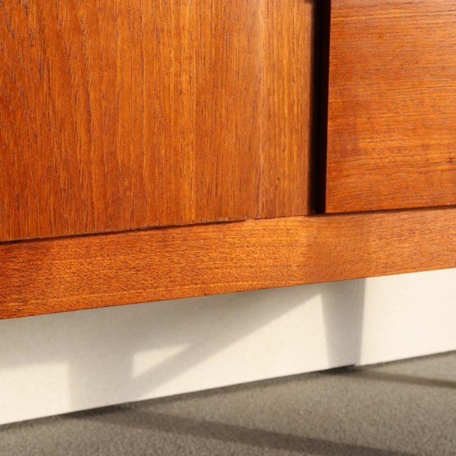 Vintage teak sideboard by Beautility with rich wood grain, mid-century British-Denmark design, clean lines, and sturdy legs.