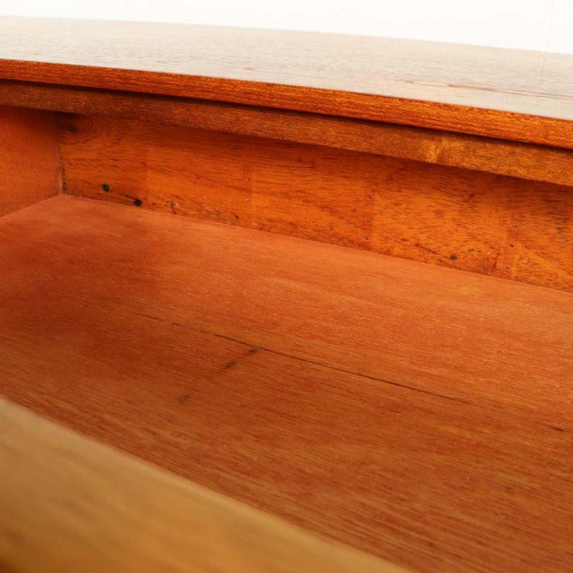 Close-up of vintage teak sideboard interior showcasing smooth wood grain and warm mid-century British design by Beautility.