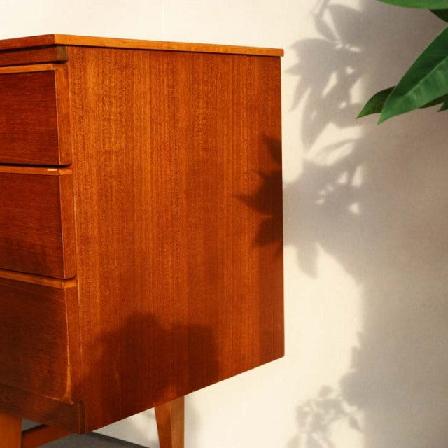 Vintage mid-century teak sideboard by Beautility, British-Danish design with rich wood grain and tapered legs.